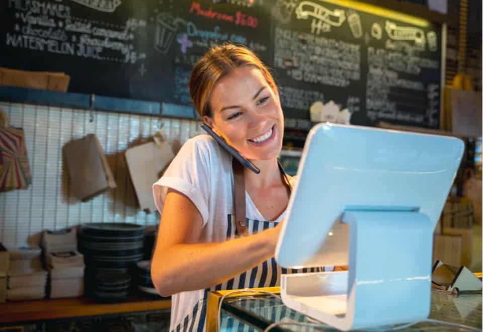 Happy Cashier on Phone — Accountants in Gold Coast, QLD