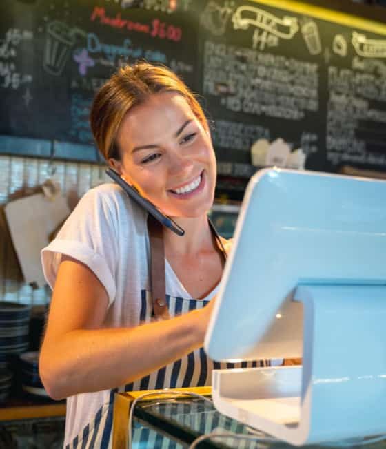 Happy Cashier on Phone — Accountants in Gold Coast, QLD